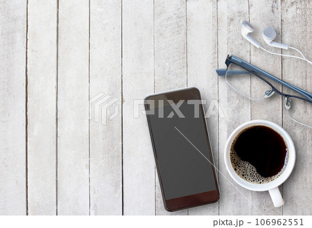 Smart phone and cup of coffee on old wooden background with copy space. 106962551
