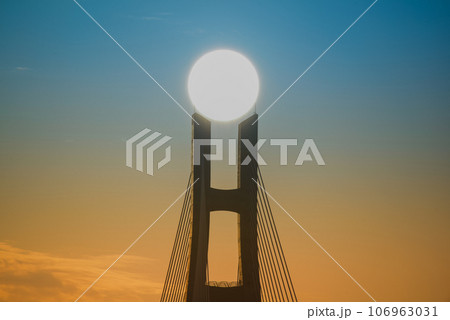 The sunset and the silhouette of the bridge piers. The sunset and the silhouette of the bridge piers. 106963031