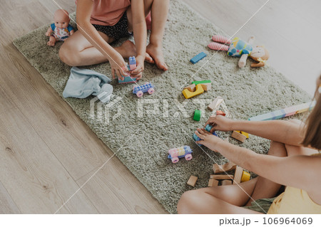 Children playing with toy building blocks on the floor at home or kindergarten Children playing with toy building blocks on the floor at home or kindergarten 106964069