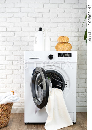 Washing machine and basket in a laundry room 106965442