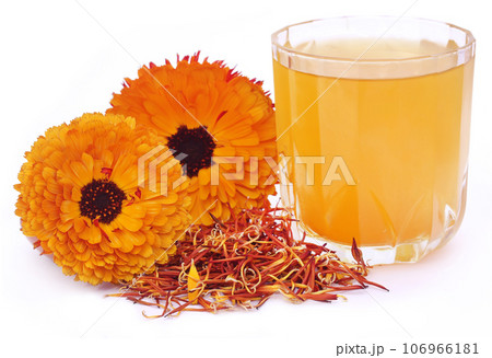 Herbal calendula flower with extract in a glass Herbal calendula flower with extract in a glass 106966181