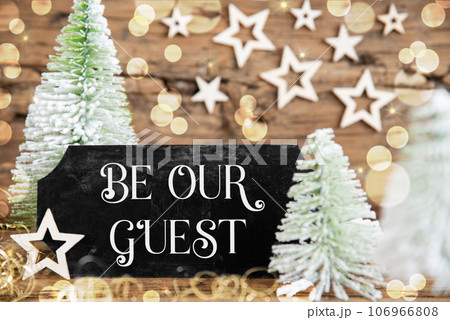 Christmas Trees, Rustic Holiday Background With Sign With Text Be Our Guest Christmas Trees, Rustic Holiday Background With Sign With Text Be Our Guest 106966808