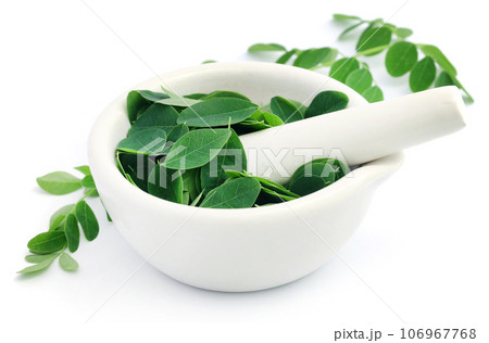Edible moringa leaves with mortar and pestle 106967768