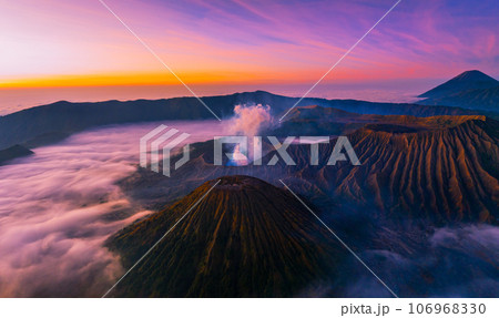 Amazing Mount Bromo volcano during sunrise from king kong viewpoint on Mountain Penanjakan in Bromo Tengger Semeru National Park,East Java,Indonesia.Nature landscape background Amazing Mount Bromo volcano during sunrise from king kong viewpoint on Mountain Penanjakan in Bromo Tengger Semeru National Park,East Java,Indonesia.Nature landscape background 106968330