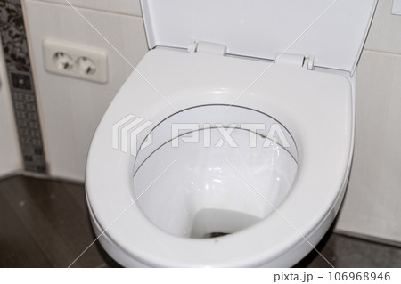 White toilet bowl in the toilet in the bathroom. The toilet before it is washed. The concept of cleaning and cleanliness. 106968946