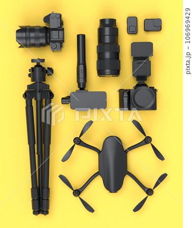 Top view of monochrome designer workspace and photography gear on yellow Top view of monochrome designer workspace and photography gear on yellow 106969429