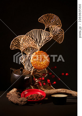 Mid-Autumn Festival themed art decoration with moon cakes, tea set in black color and a plate of melon seeds. Mid-autumn festival mooncake minimalist style tea party table Mid-Autumn Festival themed art decoration with moon cakes, tea set in black color and a plate of melon seeds. Mid-autumn festival mooncake minimalist style tea party table 106969560