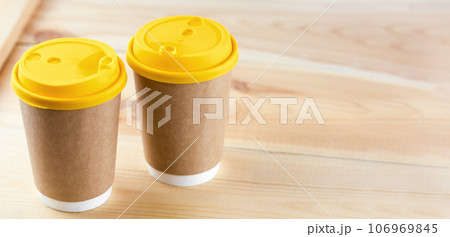 Two Disposable Coffee Cups on table top. 106969845