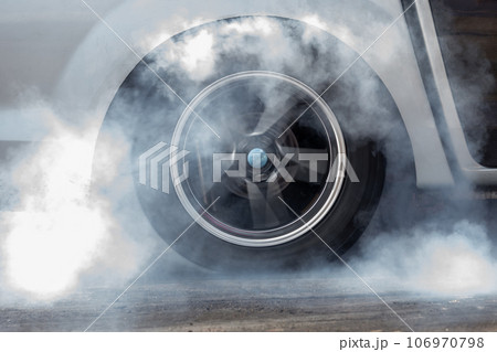 Close up car wheel with smoke on the asphalt road speed track, Car wheel drifting and smoking on track, Car wheel spinning. Close up car wheel with smoke on the asphalt road speed track, Car wheel drifting and smoking on track, Car wheel spinning. 106970798