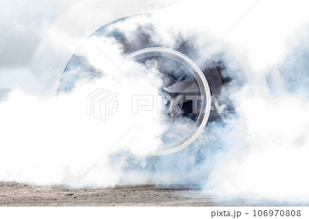 Close up car wheel with smoke on the asphalt road speed track, Car wheel drifting and smoking on track, Car wheel spinning. Close up car wheel with smoke on the asphalt road speed track, Car wheel drifting and smoking on track, Car wheel spinning. 106970808