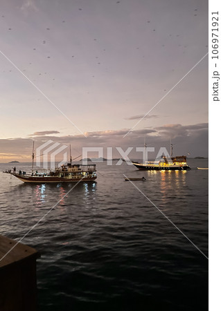 Two yachts at sea at sunset closeup 106971921