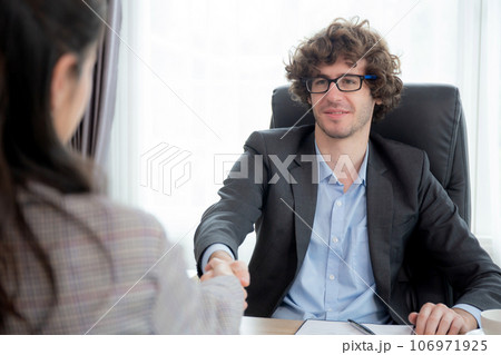 Young asian businesswoman job interview with caucasian manager and agreement with handshake. 106971925