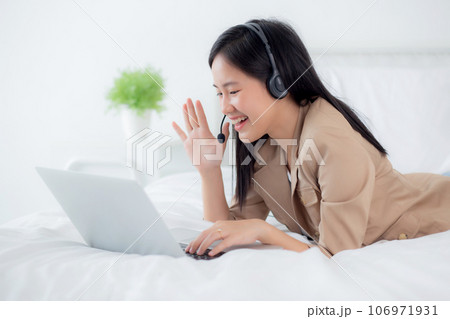 Young asian woman using laptop computer for video conference distance with online to friends. 106971931