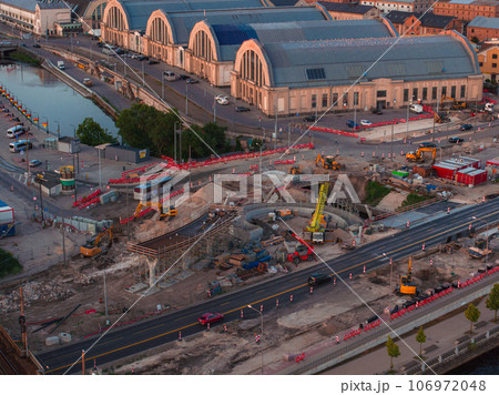 Building Rail Baltica project in the cenetr of Riga. Construction works of roads, railway and bridges in Riga. 106972048
