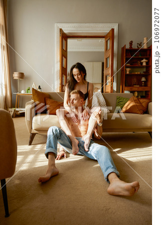 Erotic half dressed couple rest together in home living room Erotic half dressed couple rest together in home living room 106972077