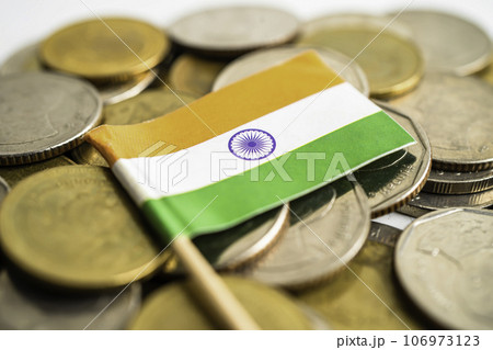 Stack of coins with India flag and US dollar banknotes. Stack of coins with India flag and US dollar banknotes. 106973123