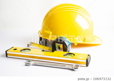 Architectural house plan project blueprint and yellow helmet with calculator, engineer construction tools. Architectural house plan project blueprint and yellow helmet with calculator, engineer construction tools. 106973132