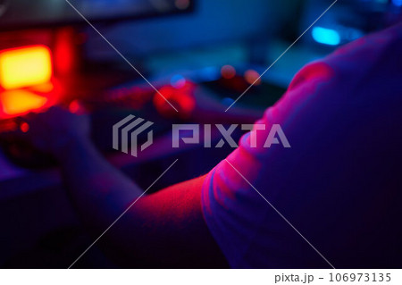Player looking at his computer screen, contemplating his next move in an online video game. Player looking at his computer screen, contemplating his next move in an online video game. 106973135