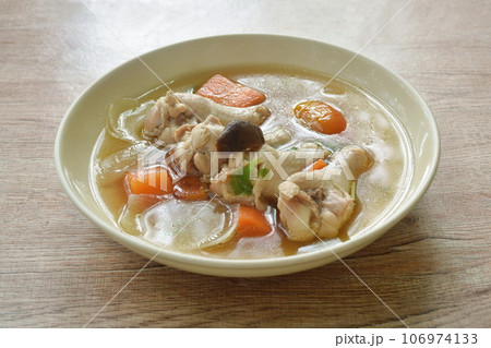 boiled braised chicken drumstick with carrot and tomato couple onion topping mushroom soup on plate boiled braised chicken drumstick with carrot and tomato couple onion topping mushroom soup on plate 106974133