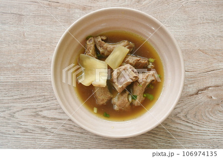 boiled braised pork bone with Chinese herb stew soup on bowl boiled braised pork bone with Chinese herb stew soup on bowl 106974135