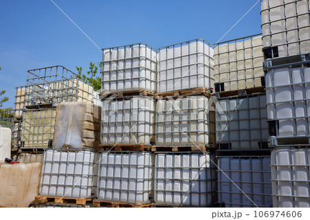 blue plastic barrel where the empty oil is stacked. 106974606