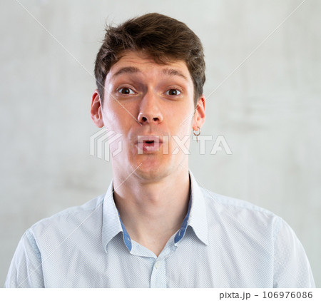 Portrait of young surprised guy in studio 106976086