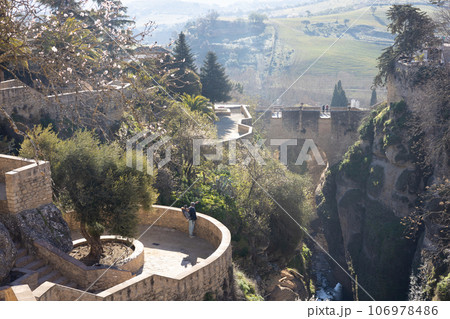 Panoramic view of hanging gardens of Cuenca over El Tajo Gorge with whitewashed houses of Ronda, Andalusia, Spain 106978486