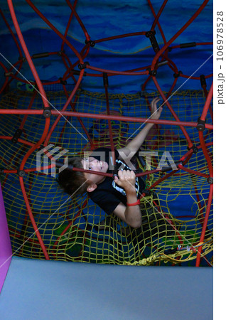 The boy climbs up the labyrinth through the web 106978528