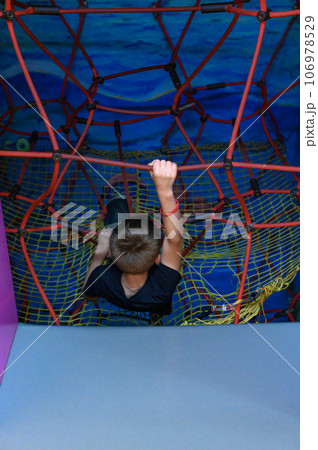 The boy climbs up the labyrinth through the web 106978529