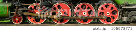 Red wheels of antique steam locomotive 106978773