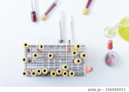 Top view of  blood samples in tubes and syringes on work table in a medical examination lab. 106980051