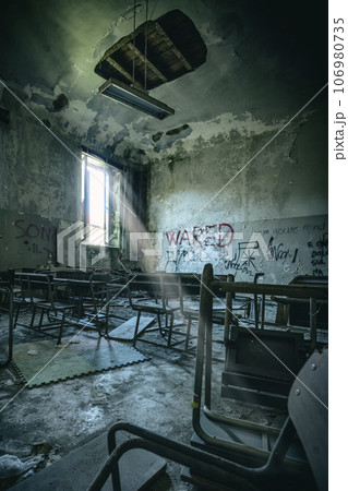 old  and vandalised interior of a school classroom 106980735