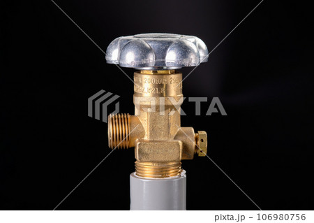 Cylinder regulator close-up on a black background 106980756