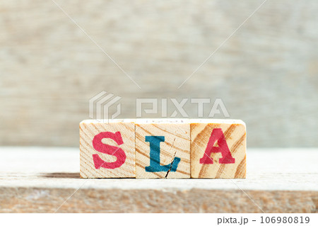 Alphabet letter block in word SLA (Abbreviation of Service level agreement) on wood background Alphabet letter block in word SLA (Abbreviation of Service level agreement) on wood background 106980819