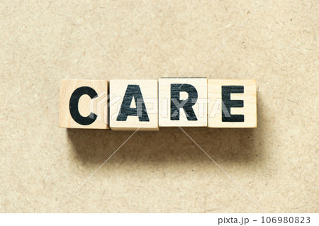 Alphabet letter block in word care on wood background 106980823