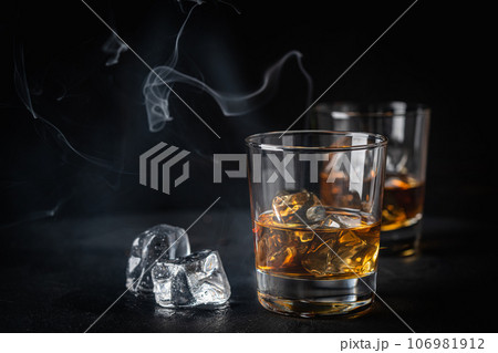 Whiskey with ice in glasses Whiskey with ice in glasses 106981912