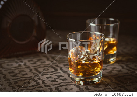 Whiskey with ice in glasses Whiskey with ice in glasses 106981913
