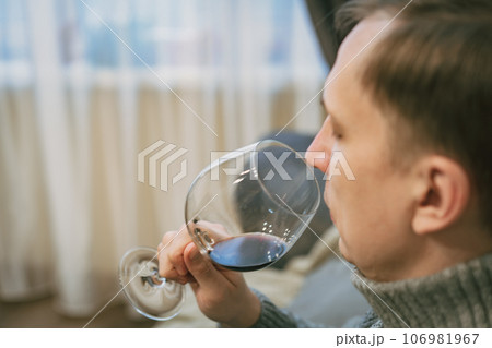 man drinking wine and relaxing man drinking wine and relaxing 106981967