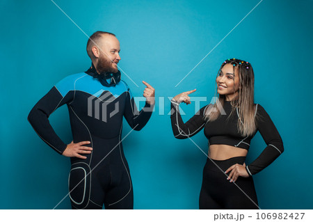 Two fit people on blue background. Happy man and woman portrait Two fit people on blue background. Happy man and woman portrait 106982427