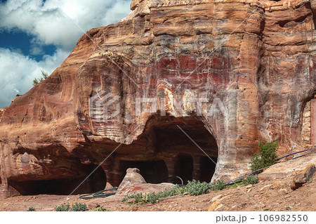 View of the caves and dwellings carved into the sandstone rock. Petra, Jordan. View of the caves and dwellings carved into the sandstone rock. Petra, Jordan. 106982550
