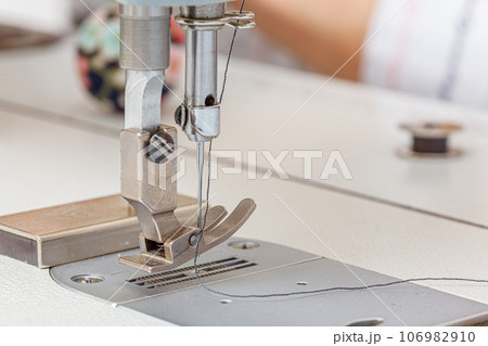 Sewing machine needle with thread and fabric 106982910