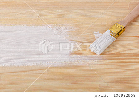 white paint with a brush on a wooden background with texture white paint with a brush on a wooden background with texture 106982958
