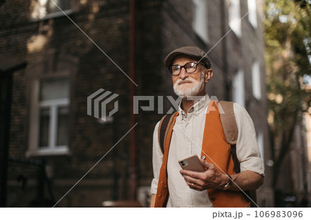 Senior tourist exploring a new city and visiting interesting sites. 106983096