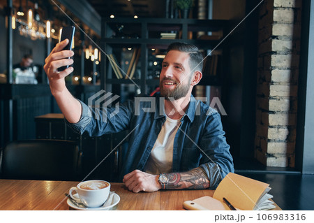 Man looking into the camera while making a selfie 106983316