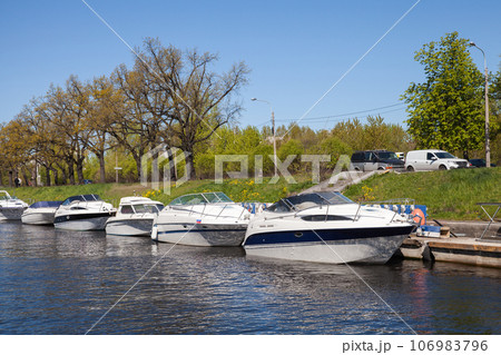 Pleasure motor boats are moored in Saint-Petersburg on a sunny day Pleasure motor boats are moored in Saint-Petersburg on a sunny day 106983796