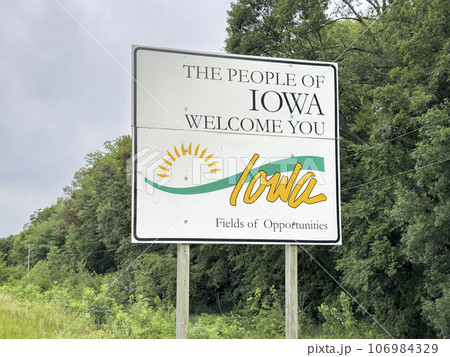 Iowa welcome roadside sign at state border with Nebraska, summer scenery, travel concept Iowa welcome roadside sign at state border with Nebraska, summer scenery, travel concept 106984329