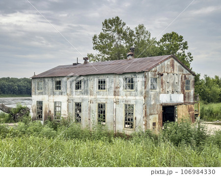 abandoned industrial building at old shipyard on the shore of Missouri River abandoned industrial building at old shipyard on the shore of Missouri River 106984330