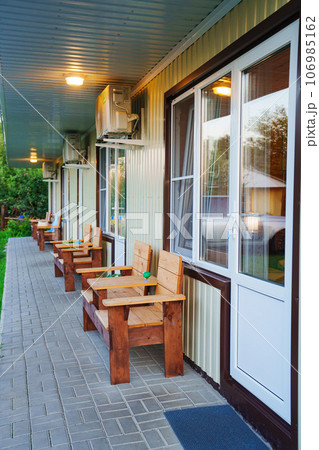 terrace with place to relax in fresh air in front of One-story motel houses. 106985162