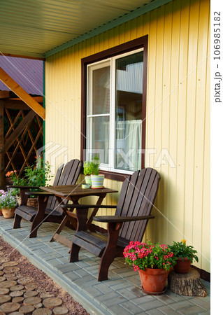 terrace with place to relax in fresh air in front of One-story motel houses. 106985182