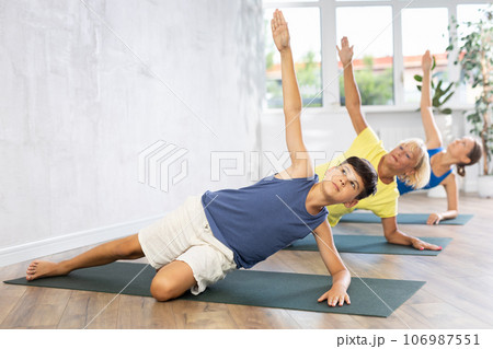 Family in training doing plank exercise to strengthen all abdominal muscle groups 106987551
